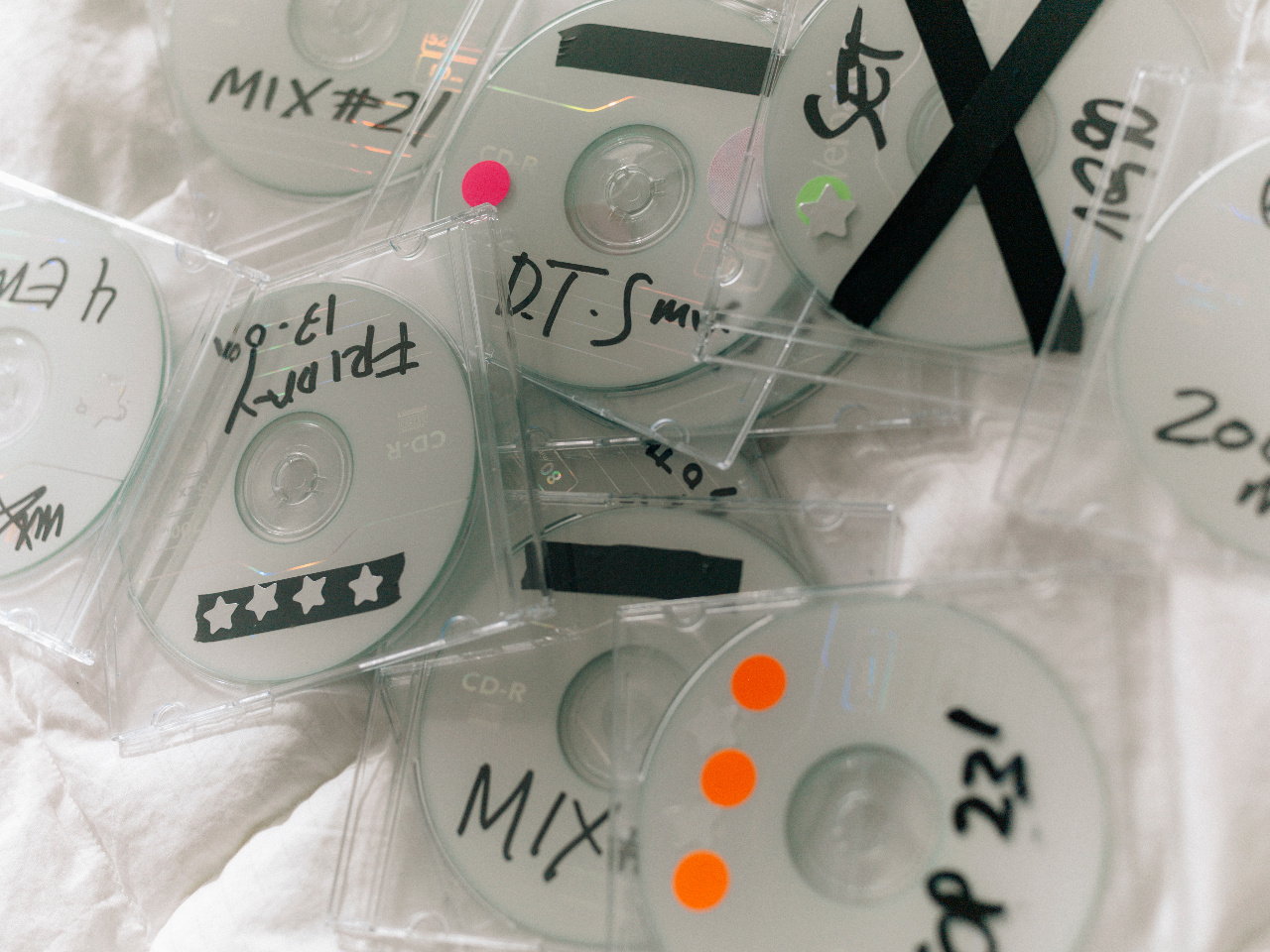 Hand-labelled discs arranged on white linen