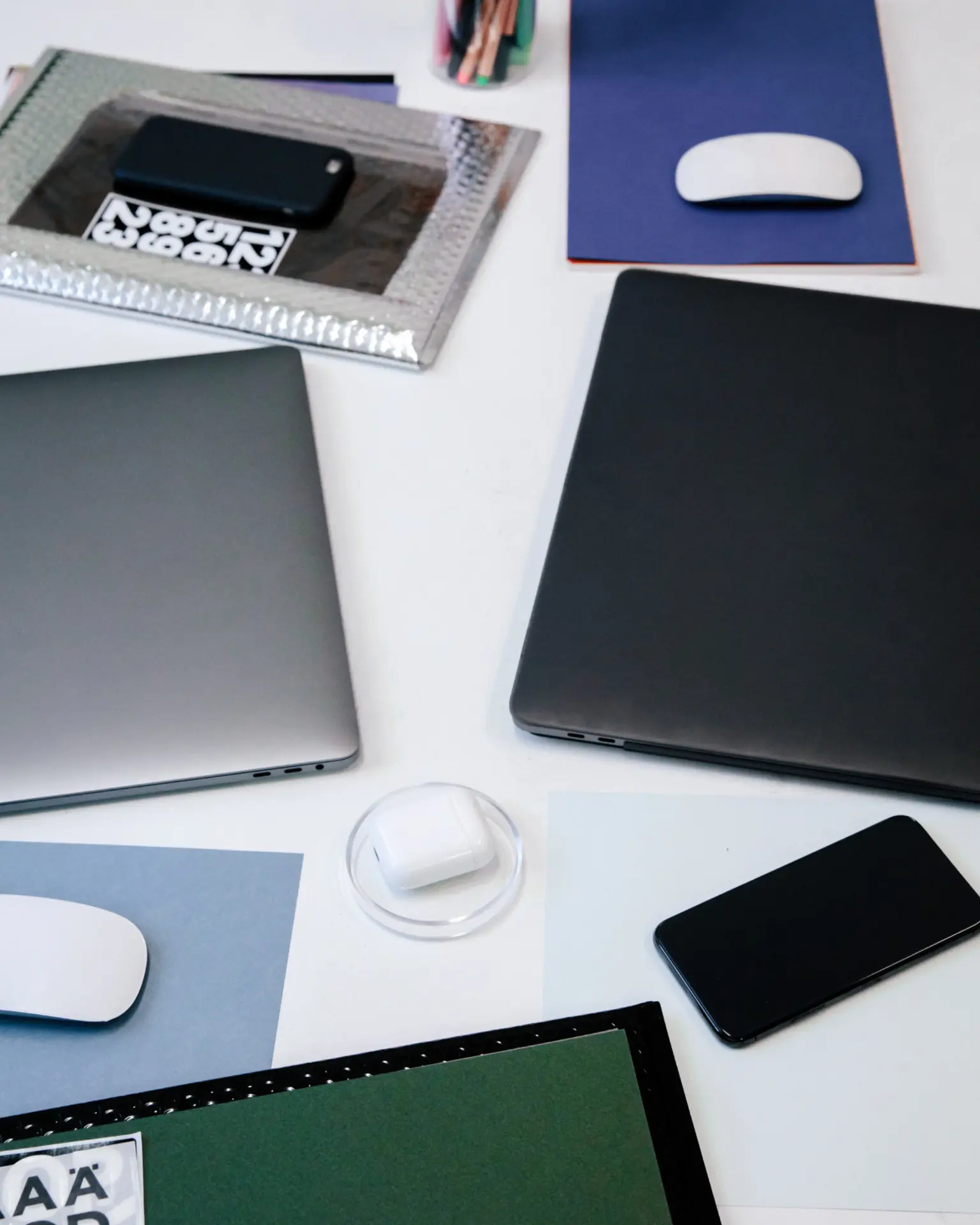 Studio desk with devices and paper swatches